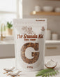 Granola packaging with 'The Granola Kid' branding on a kitchen counter.